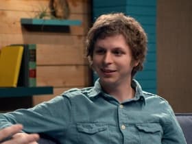 Michael Cera Wears a Blue Denim Shirt & Red Pants